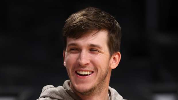 Mar 8, 2024; Los Angeles, California, USA; Los Angeles Lakers guard Austin Reaves (15, right) smiles on the bench prior to the game against the Milwaukee Bucks at Crypto.com Arena. 